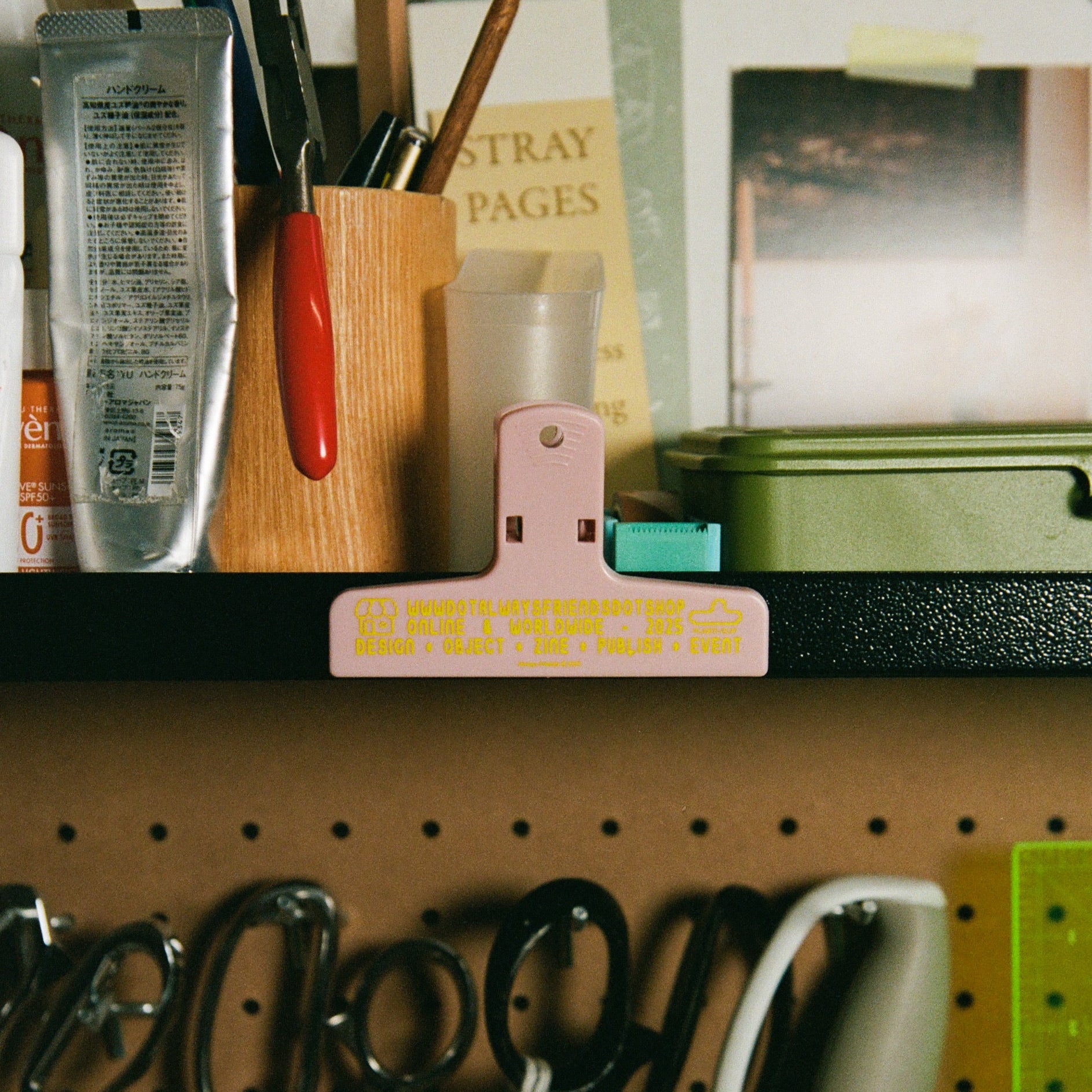 Pegboard with stationery items including scissors, a hole punch, and a ruler.