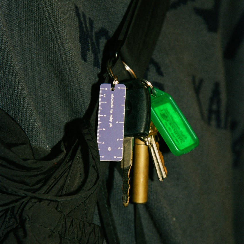 Keychain with colorful keys attached to a dark fabric background